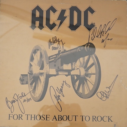 A signed AC/DC album with five autographs of; Angus Young, Phil Rudd, Cliff Williams, Brian Johnson and Malcolm Young, all signed in black felt tip on the cover of the album ‘For Those About To Rock’, framed. Condition -